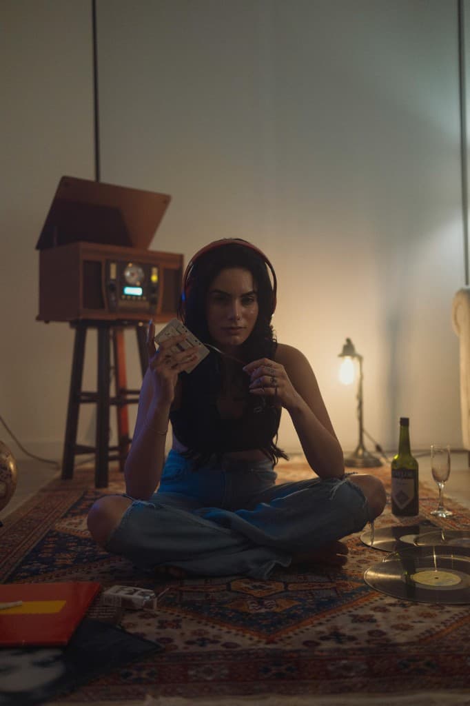 Someone flipping through cassettes by a turntable